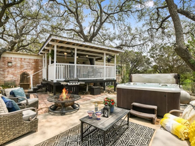 Private hot tub and great patio separated from host house by a garage. It's a 5-min walk to the lake down the driveway.Fire pit for amazing campfires and propane grill. No direct view to water but beautiful large trees around you.