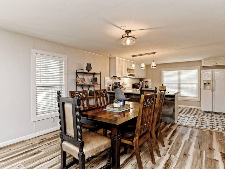 Comfortable wood table offers six chairs for dining. The inside living and dining room feels very open.
