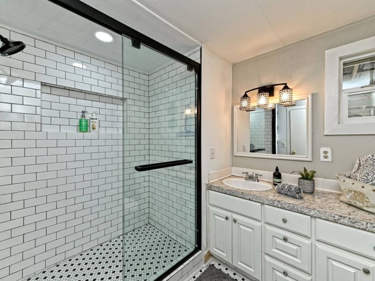 We added a brand new oversized glass shower with subway tiles and b/w tile for that vintage vibe.