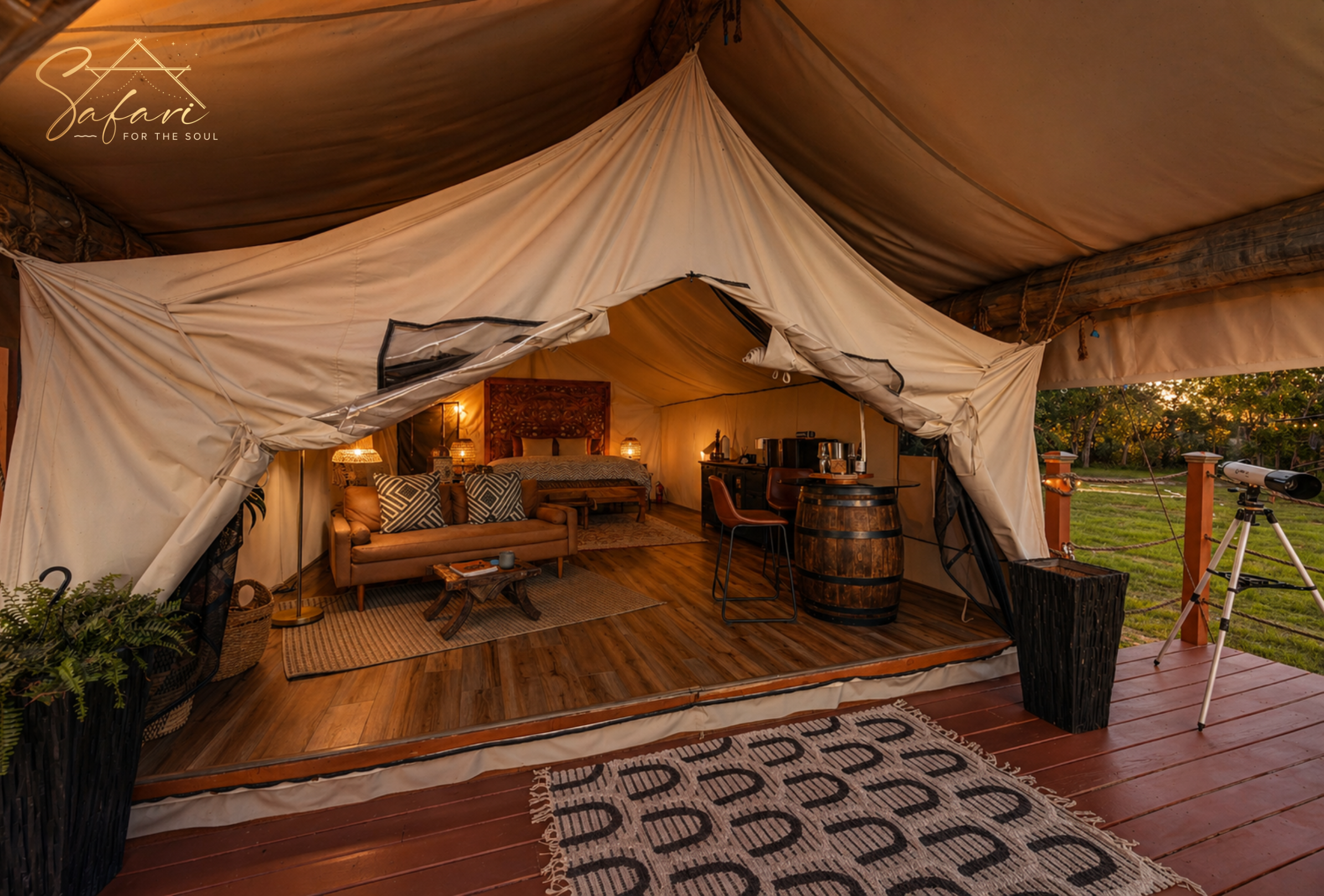 Luxury yurt interior with king bed, lounge seating, kitchenette, and telescope at Starry Nights Yurt in Marble Falls, TX.