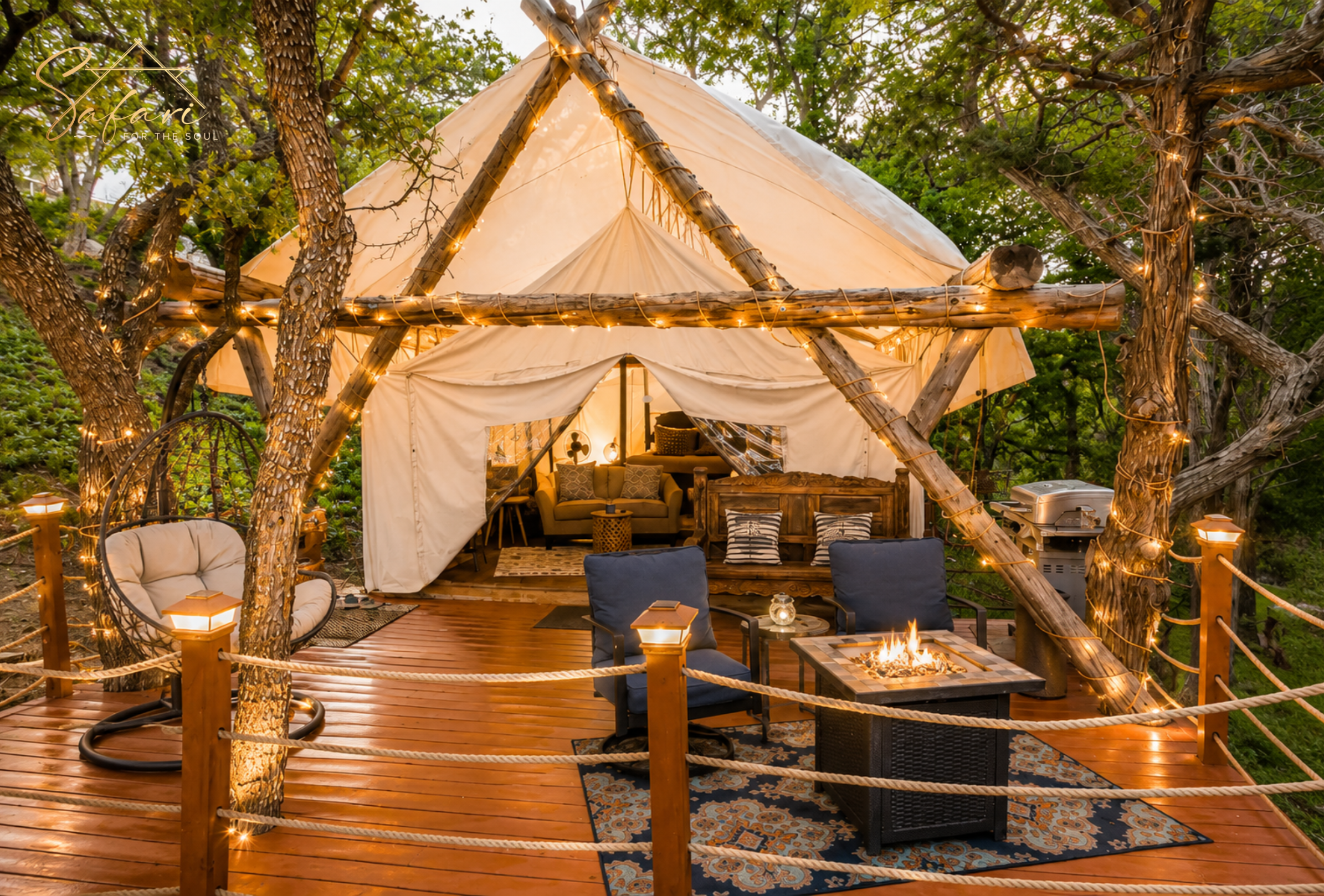 Luxury glamping tent deck with fire pit seating and string lights in Spicewood Texas