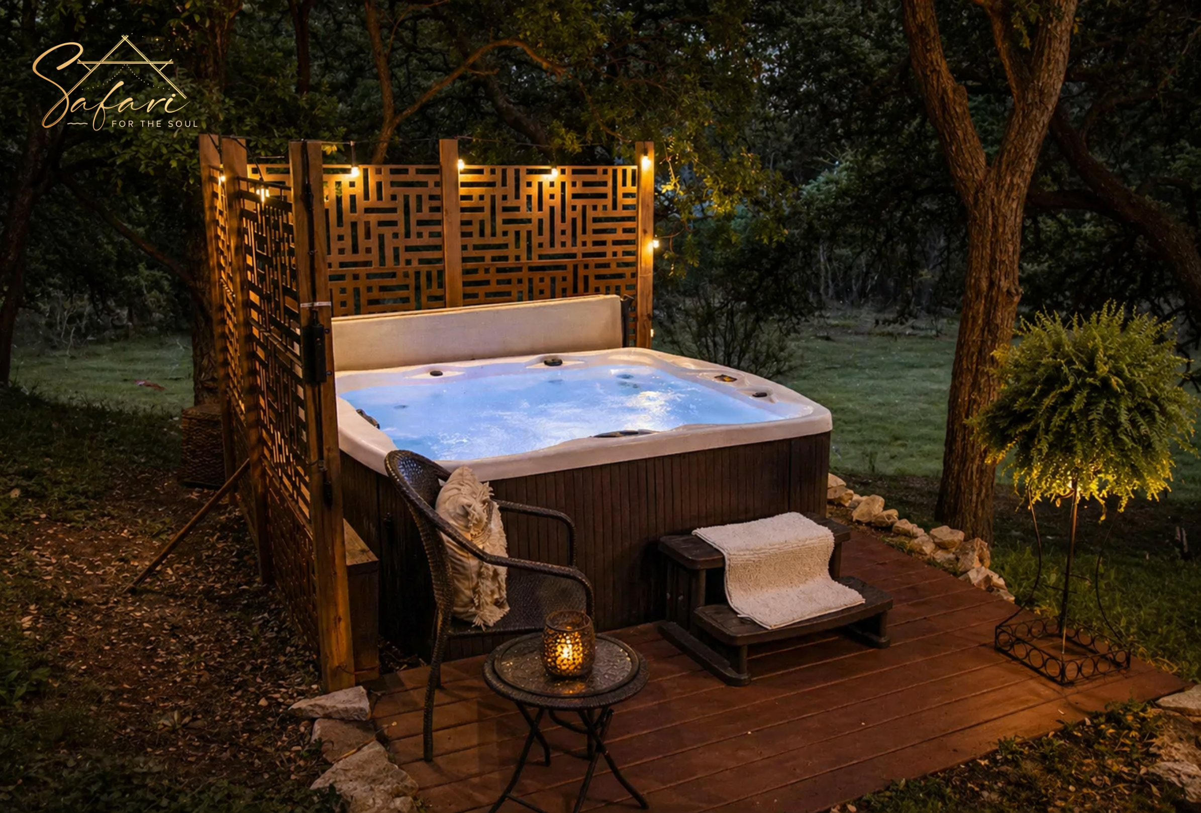 Outdoor hot tub with privacy screen and warm lighting in forest setting