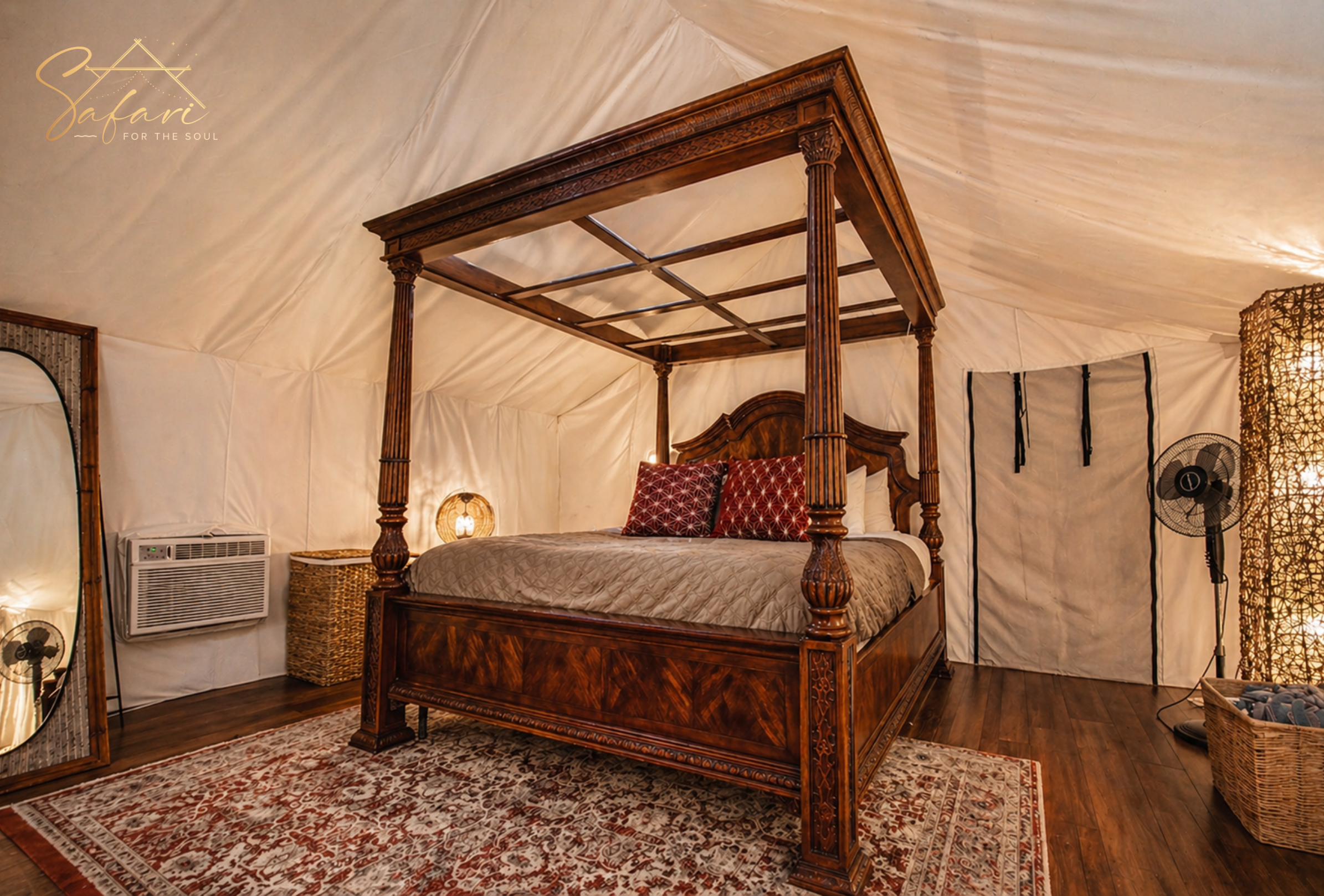 Luxury canopy bed with elegant decor and soft lighting inside glamping tent
