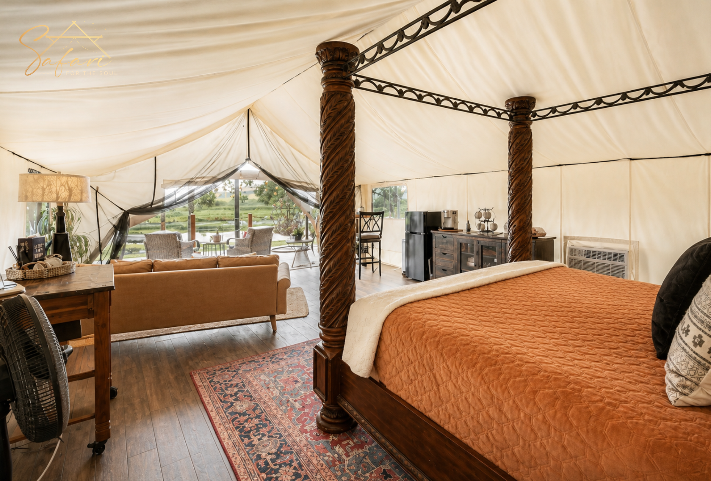 Night view of luxury glamping yurt with warm lights and fire pit under stars
