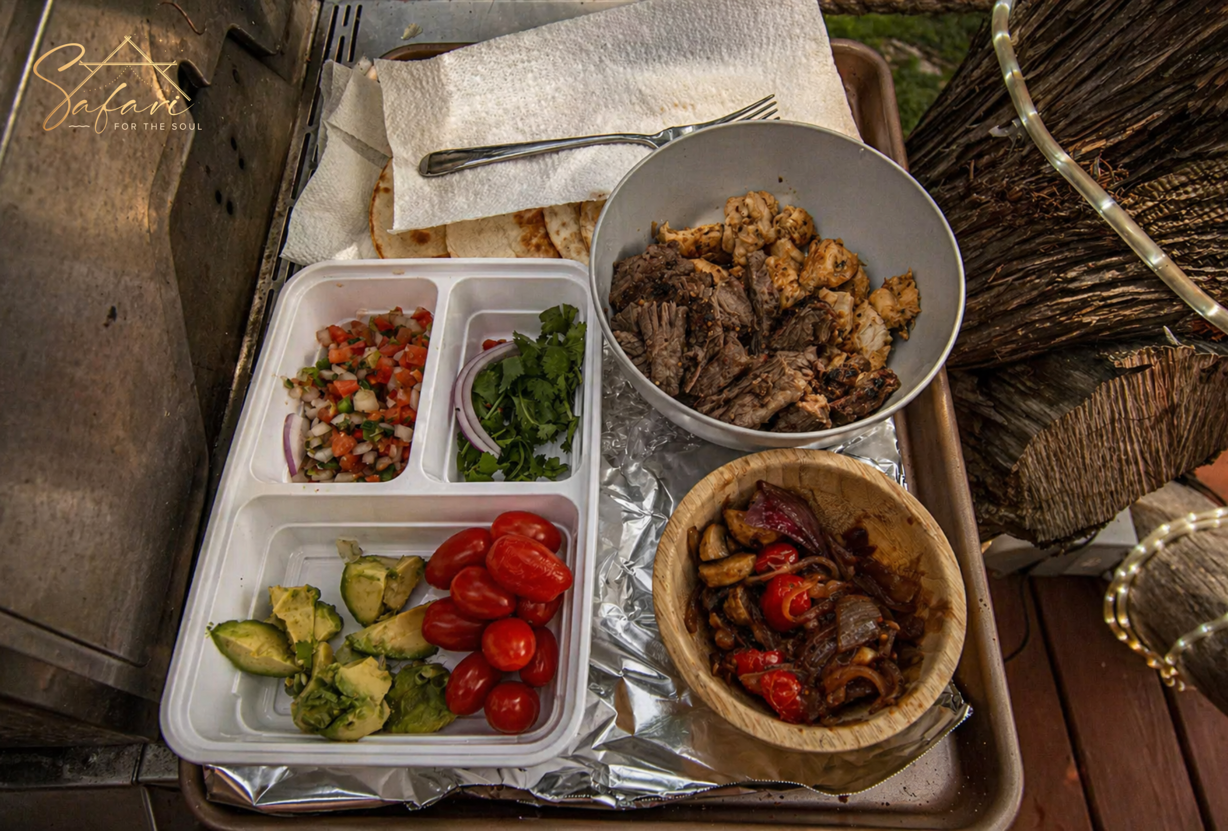 Grilled food ingredients including vegetables and meat prepared on outdoor grill