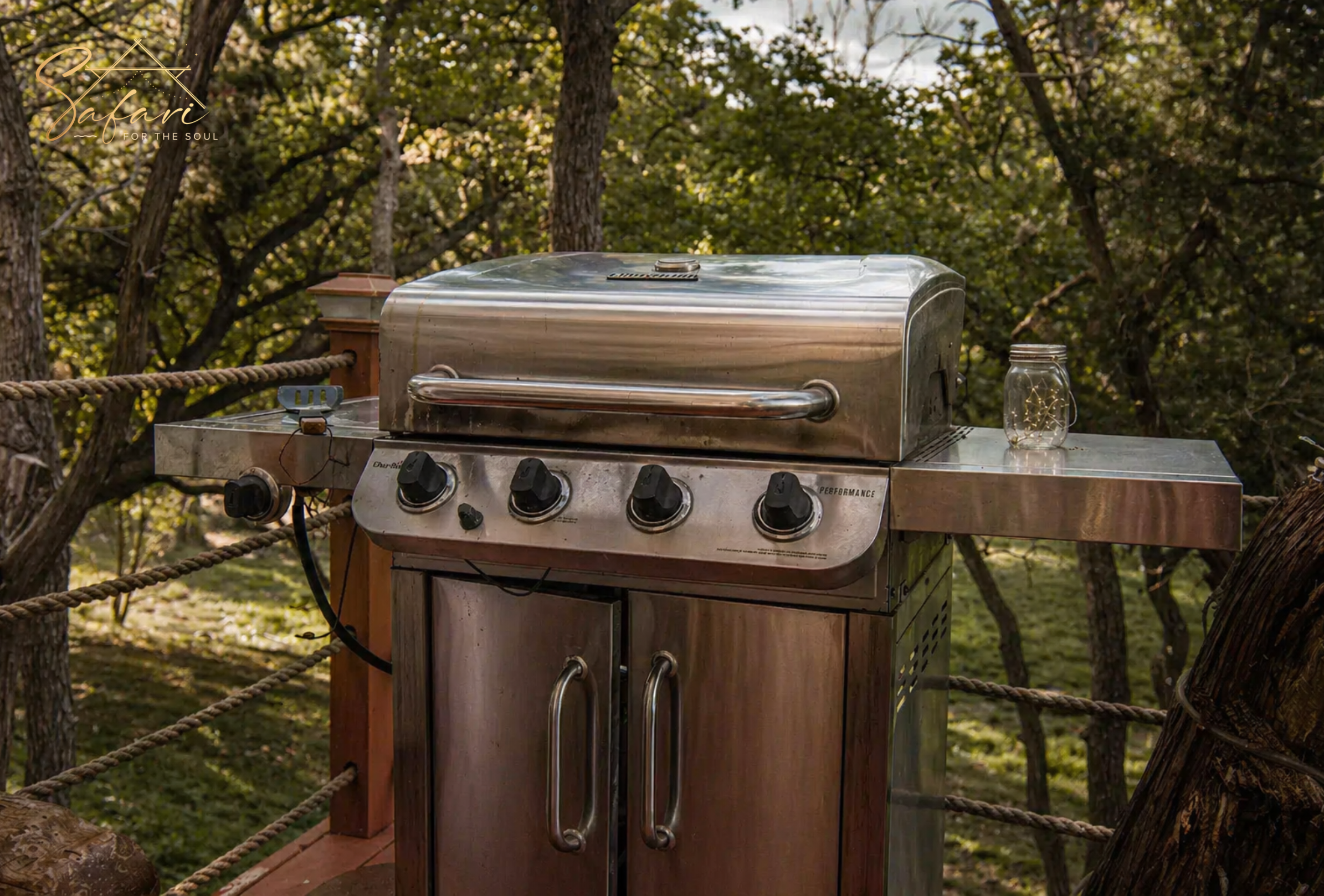 Luxury outdoor grill on private deck at Tentation Yurt glamping stay in Spicewood Texas surrounded by forest views