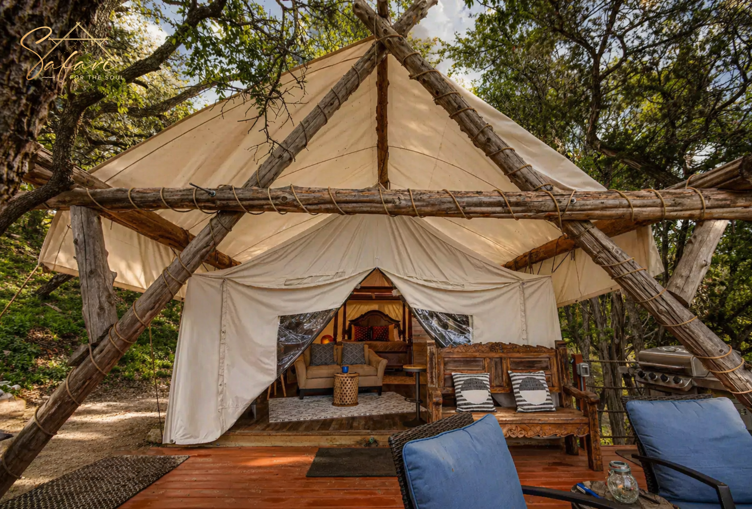 Front view of luxury glamping tent with wooden structure and cozy outdoor seating in Spicewood Texas