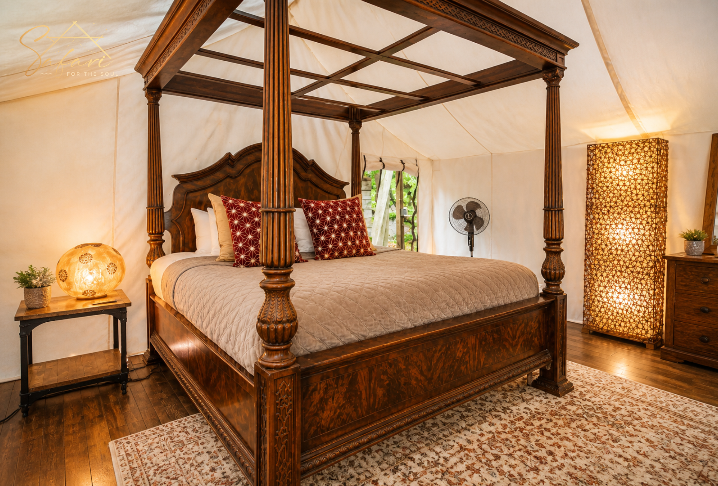 Luxury canopy bed inside safari tent with elegant decor and warm lighting in Spicewood Texas