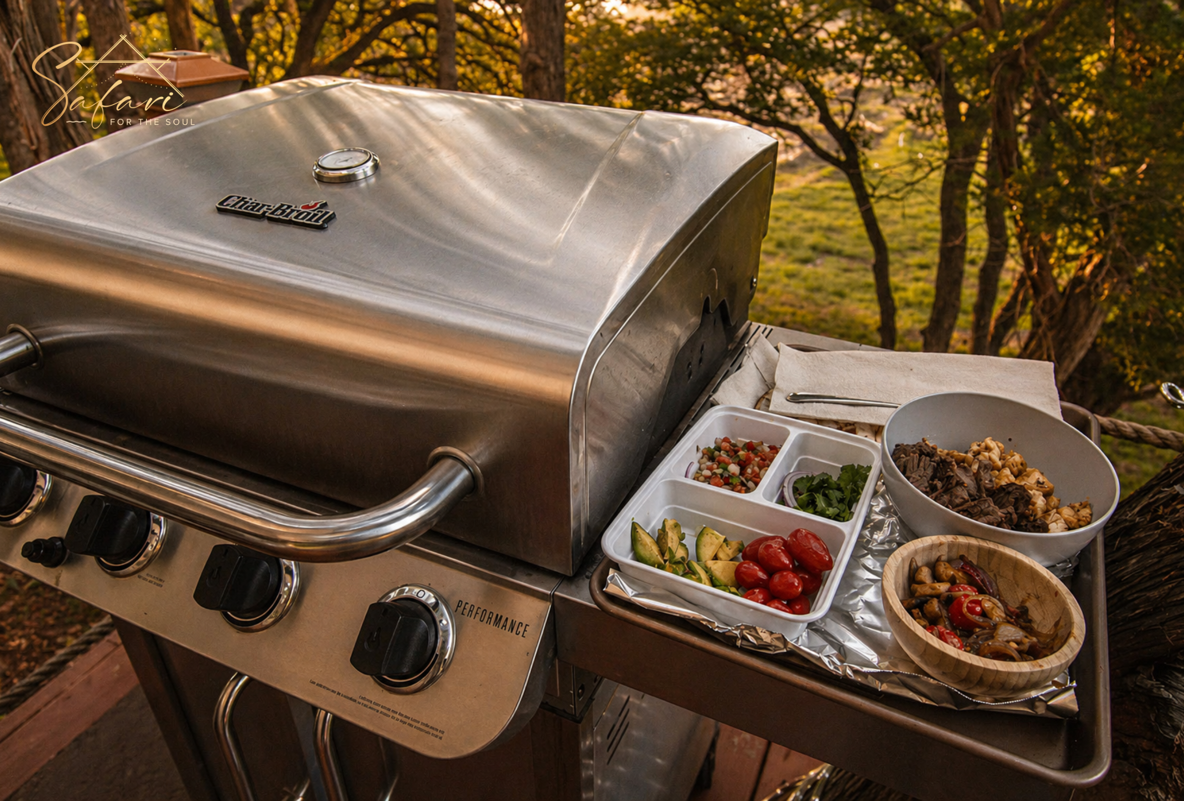 Outdoor BBQ grill with fresh ingredients prepared for cooking at luxury campsite