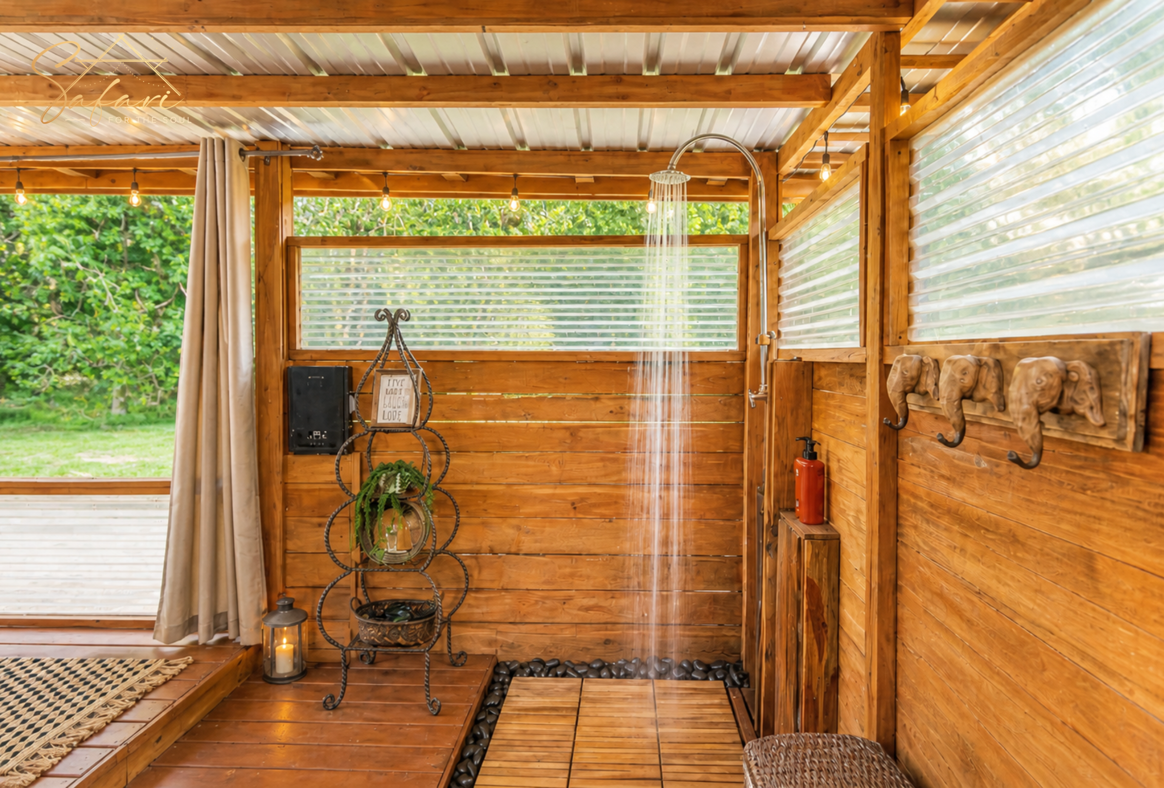Outdoor luxury shower area with wooden enclosure and modern fixtures in glamping setup