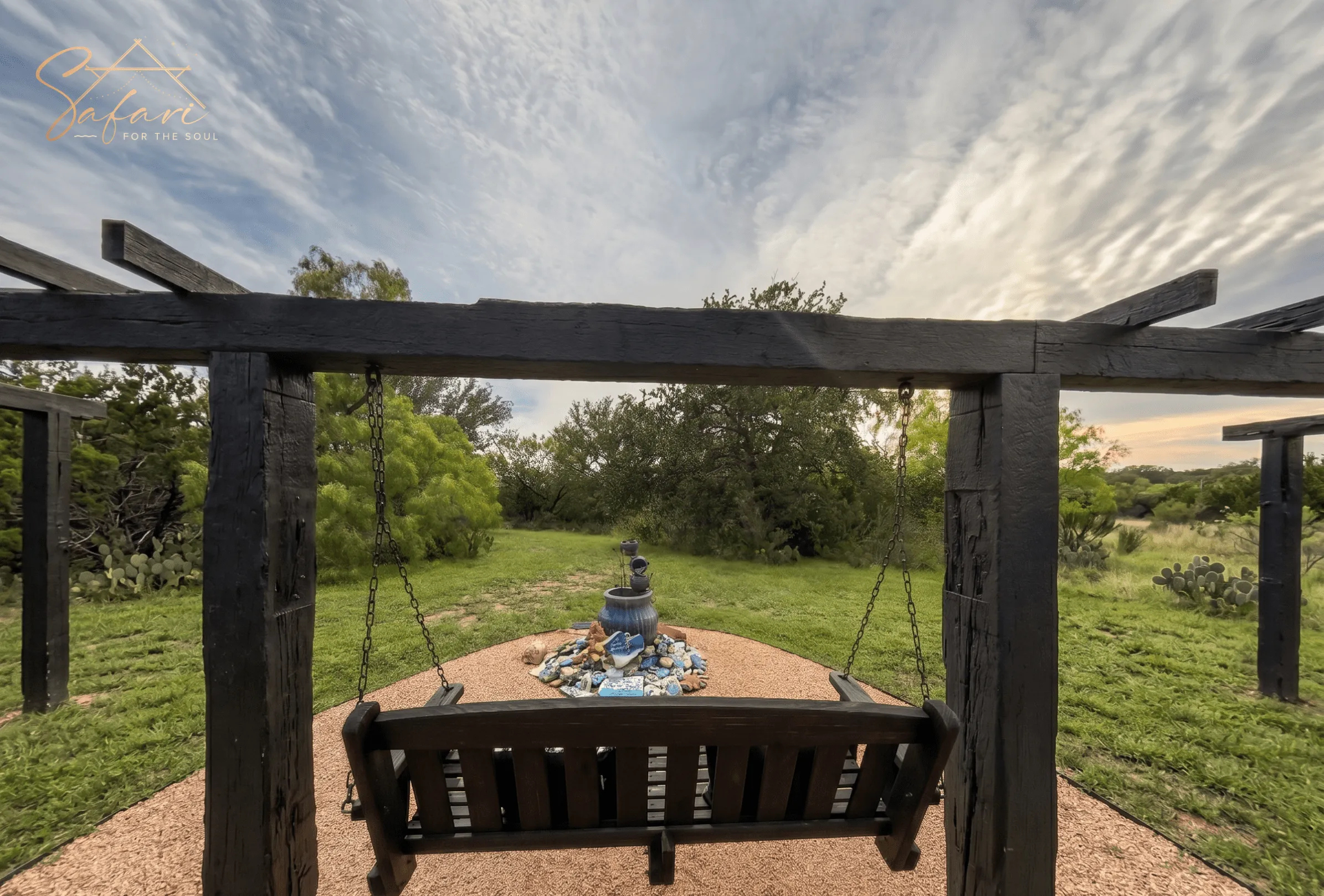 Outdoor wooden swing with scenic nature view at luxury glamping site Marble Falls Texas