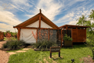 Front exterior view of Cosmic Nights luxury glamping yurt in Marble Falls Texas with landscaped entrance and modern outdoor design