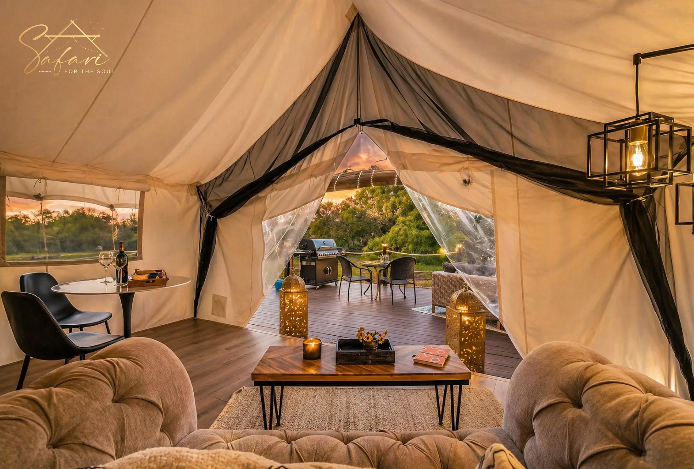 Luxury glamping tent interior with cozy seating and open view to private deck Marble Falls TX