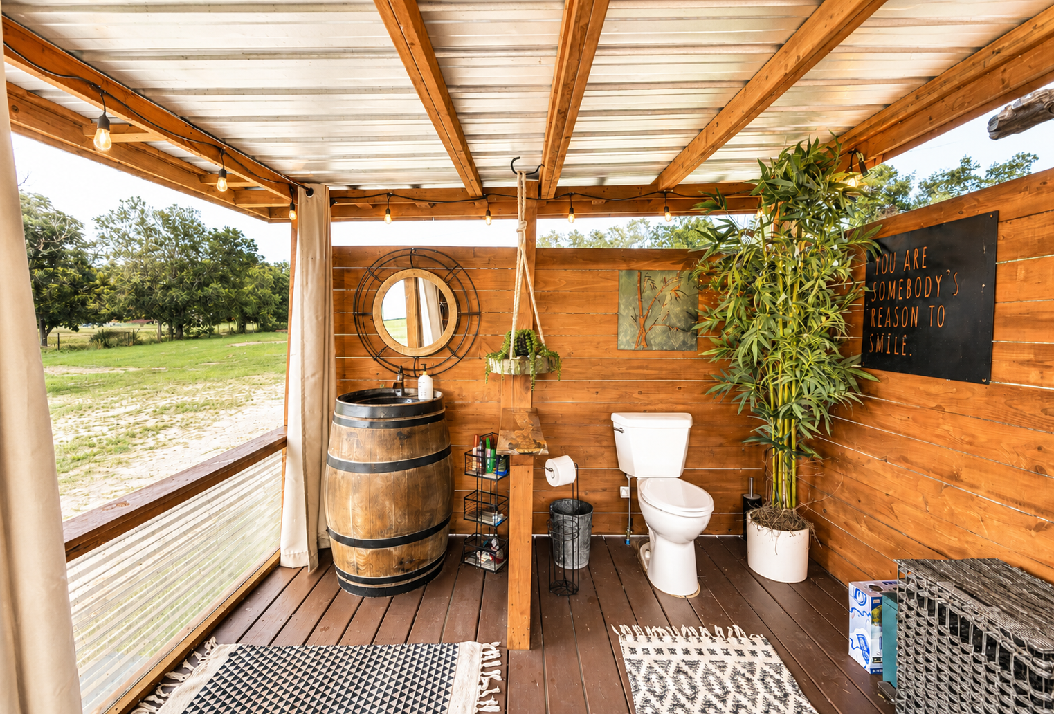 Outdoor bathroom with wooden design, toilet, and sink at luxury glamping site Marble Falls TX