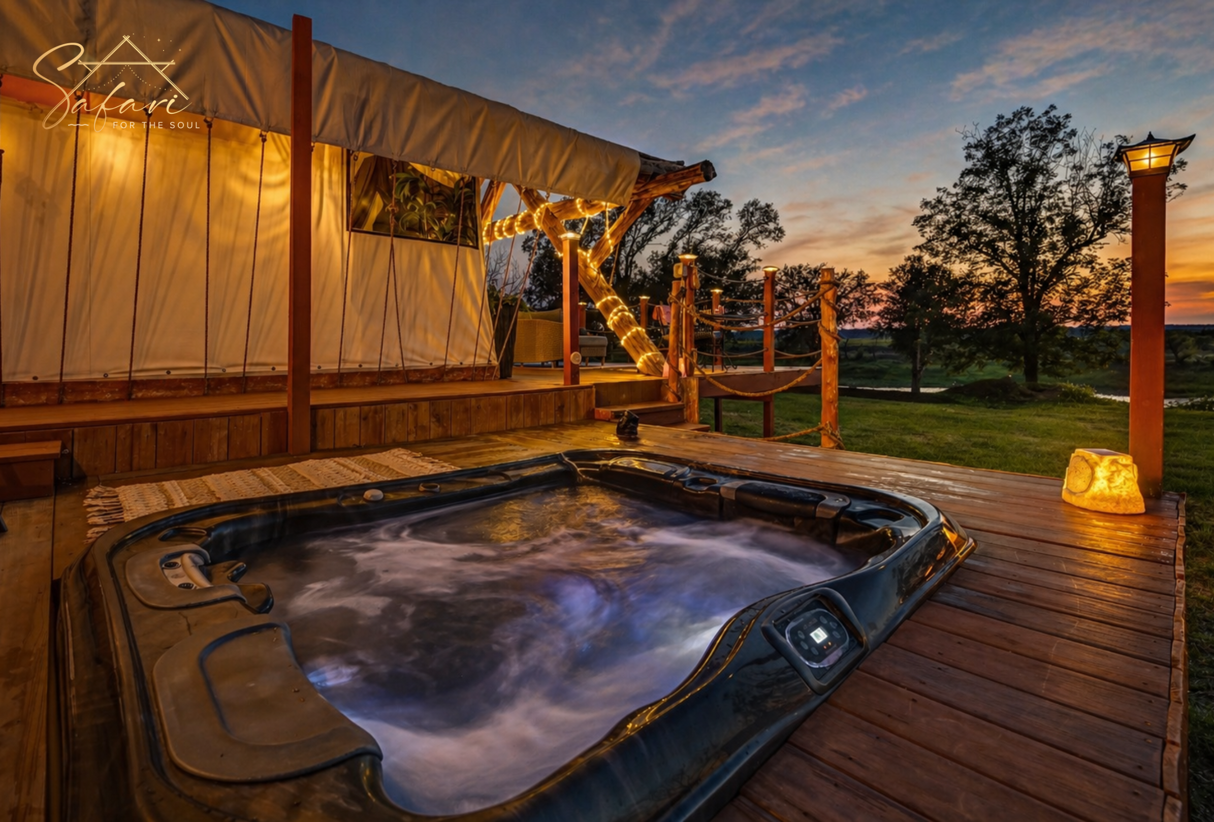 Private outdoor hot tub on wooden deck beside luxury safari tent in Marble Falls TX