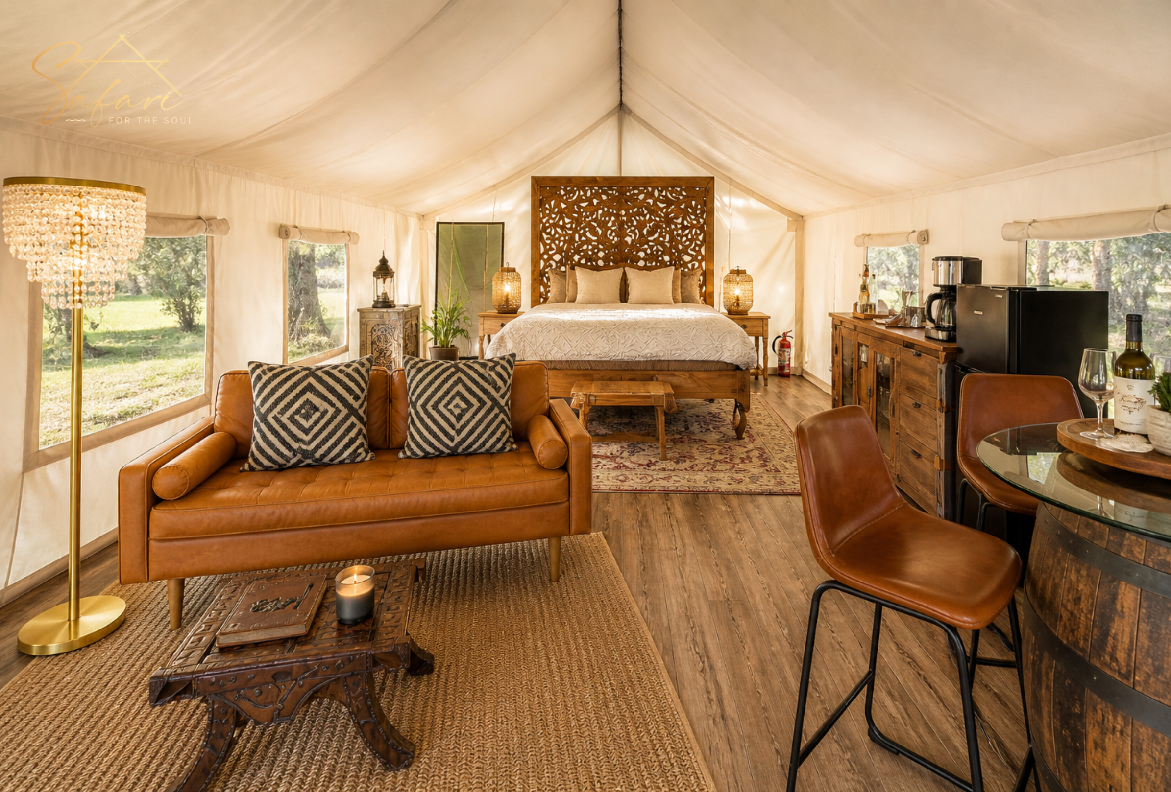 Luxury glamping yurt interior with king bed, wooden decor, and cozy seating in Marble Falls TX